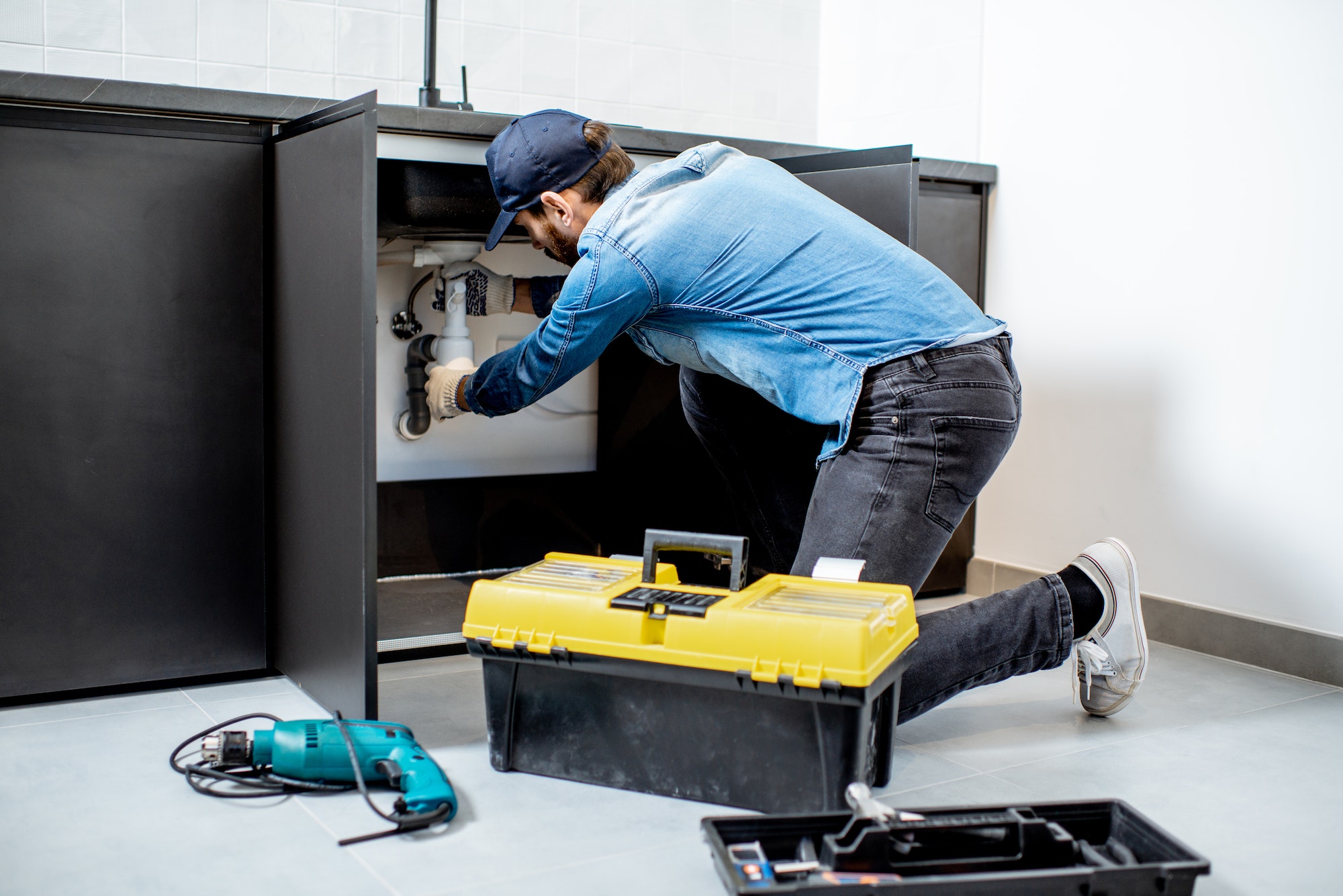 man-repairing-kitchen-furniture-3